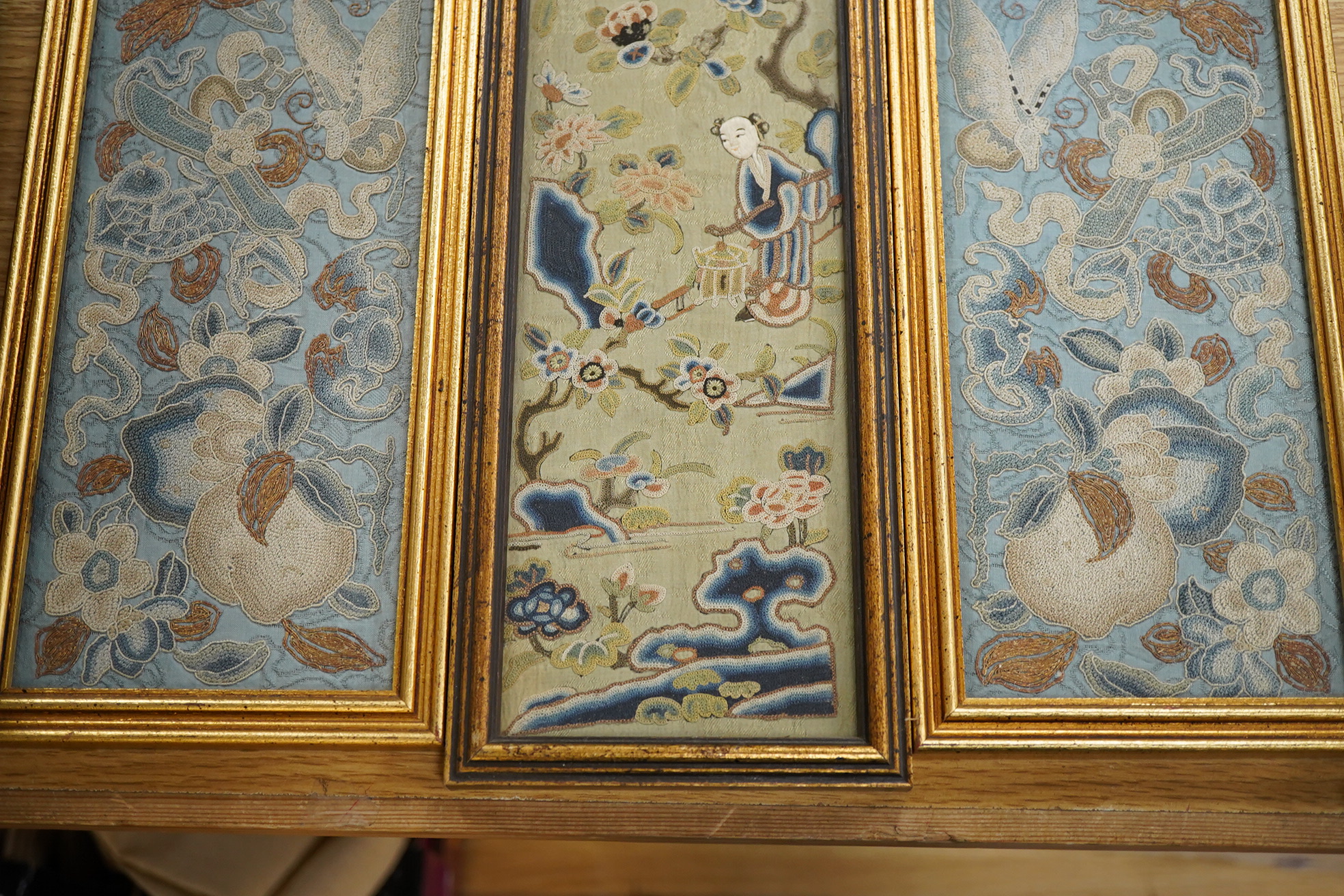 Three late 19th / early 20th century Chinese Peking Chinese knot sleeve bands including a pair of floral and butterfly blue silk sleeve bands and a single green damask figural sleeve band, 52cm x 9.5cm. Condition - good,